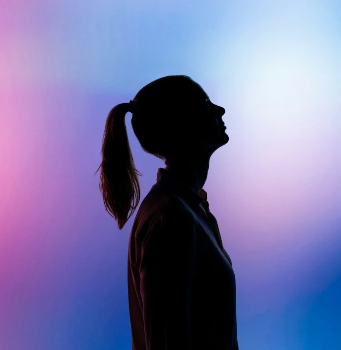 silhouette of woman wearing black hat and black coat